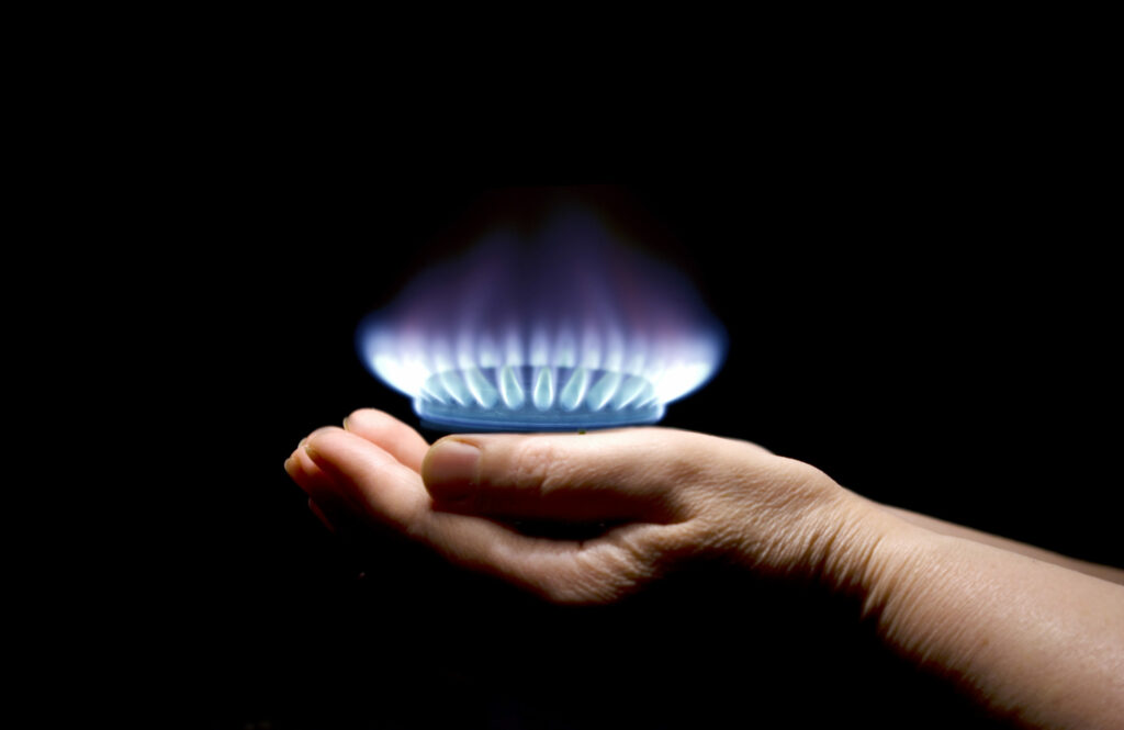 Hands holding a flame gas