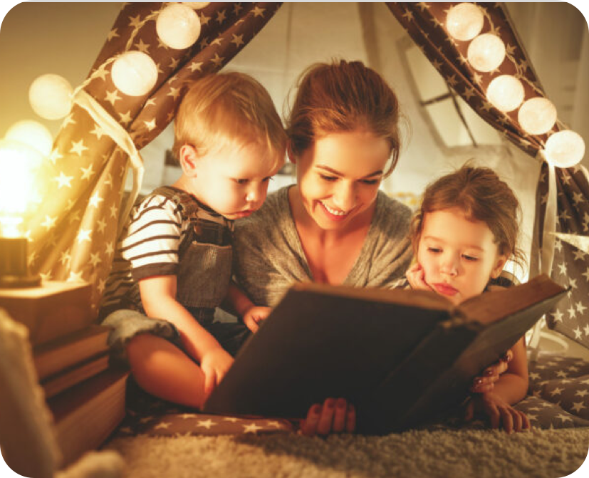 Eine Mutter ließt ihren Kindern etwas vor.